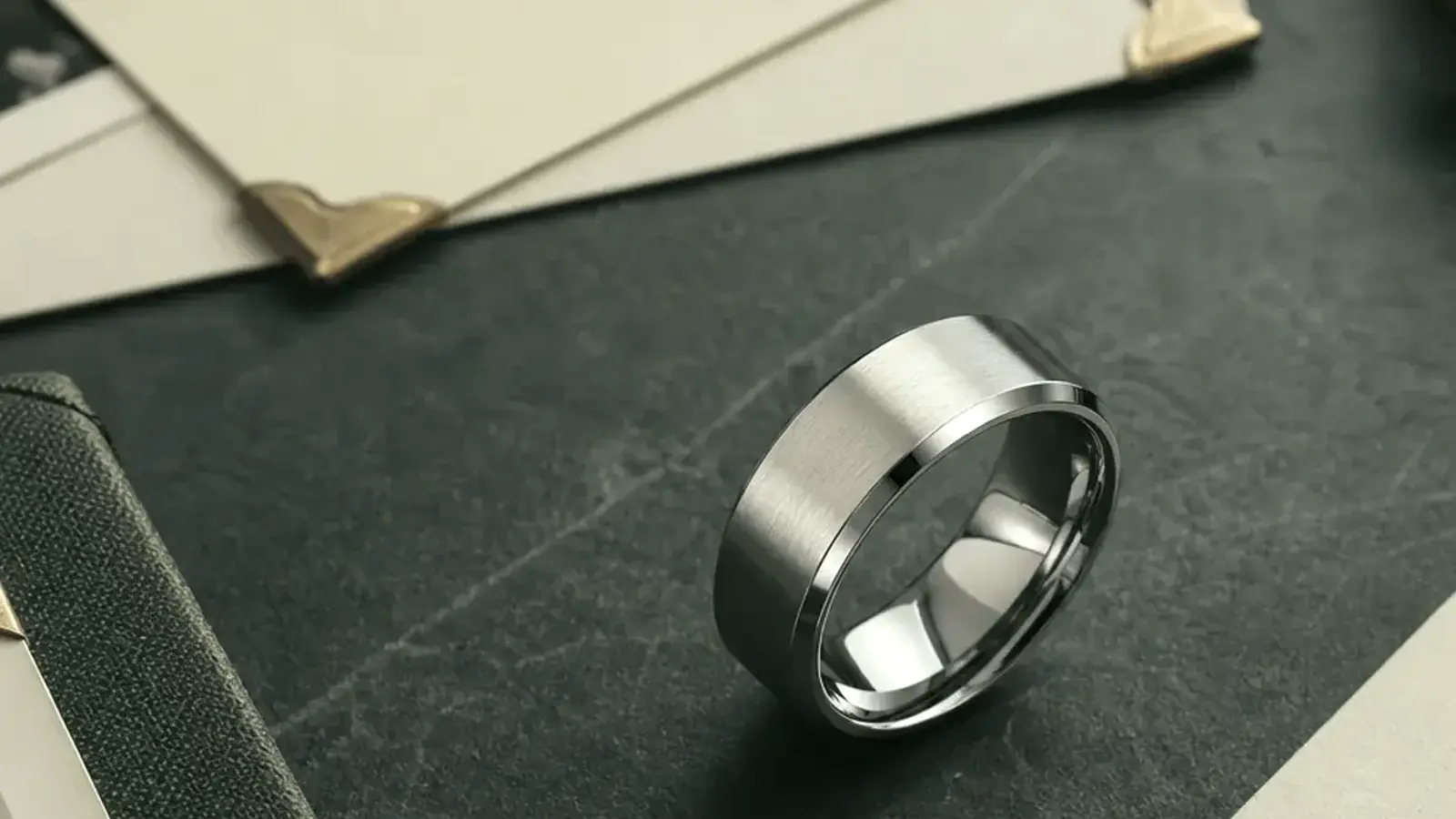 Early pregnancy loss memorial ring with a soft silver band, tiny flower detail, and private remembrance card